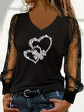 Glitzerndes Langarmshirt mit Herz-Strass
