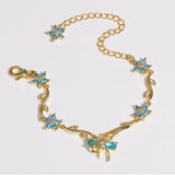 Modell: Schleife Blau Zirkon Gold