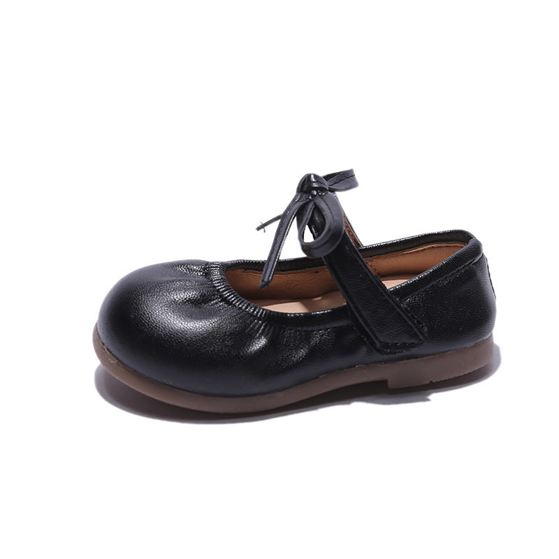 Schwarze Kinderschuhe mit Schleife