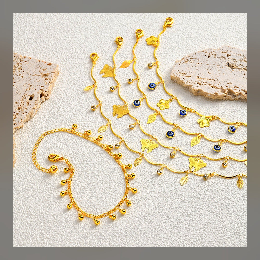 LuxeStyle-Edit · Sommer-Armband «Évil» · Schmetterling & Nazar-Auge, vergoldet